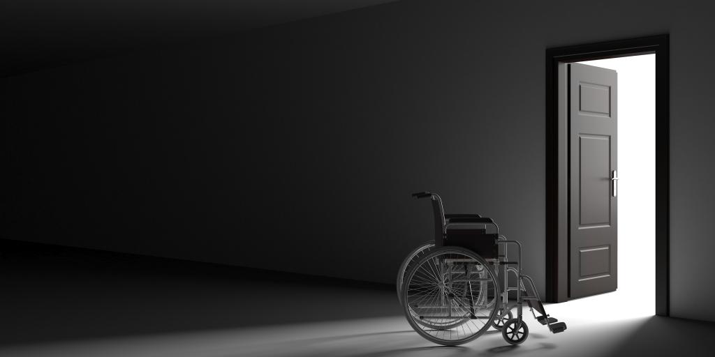 empty wheelchair in dark hallway