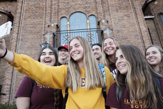 Students posing for a selfie in front of Francis Hall