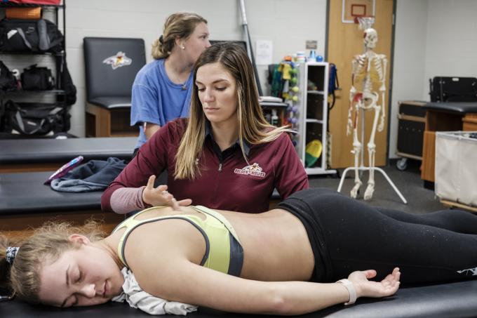Application of friction massage/trigger point release to patient. Melanie Rynshall, assistant athletic trainer.
