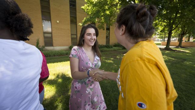 Female students shaking hands