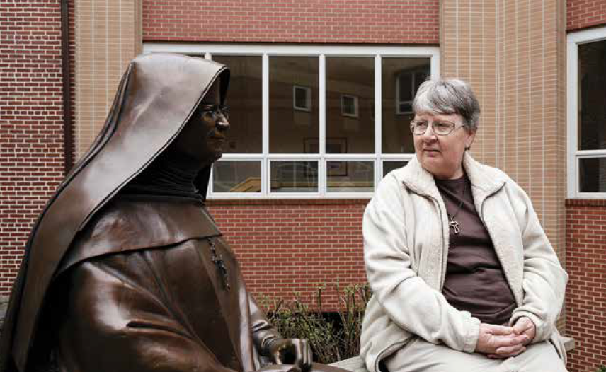 Sister Bridget looking at statue