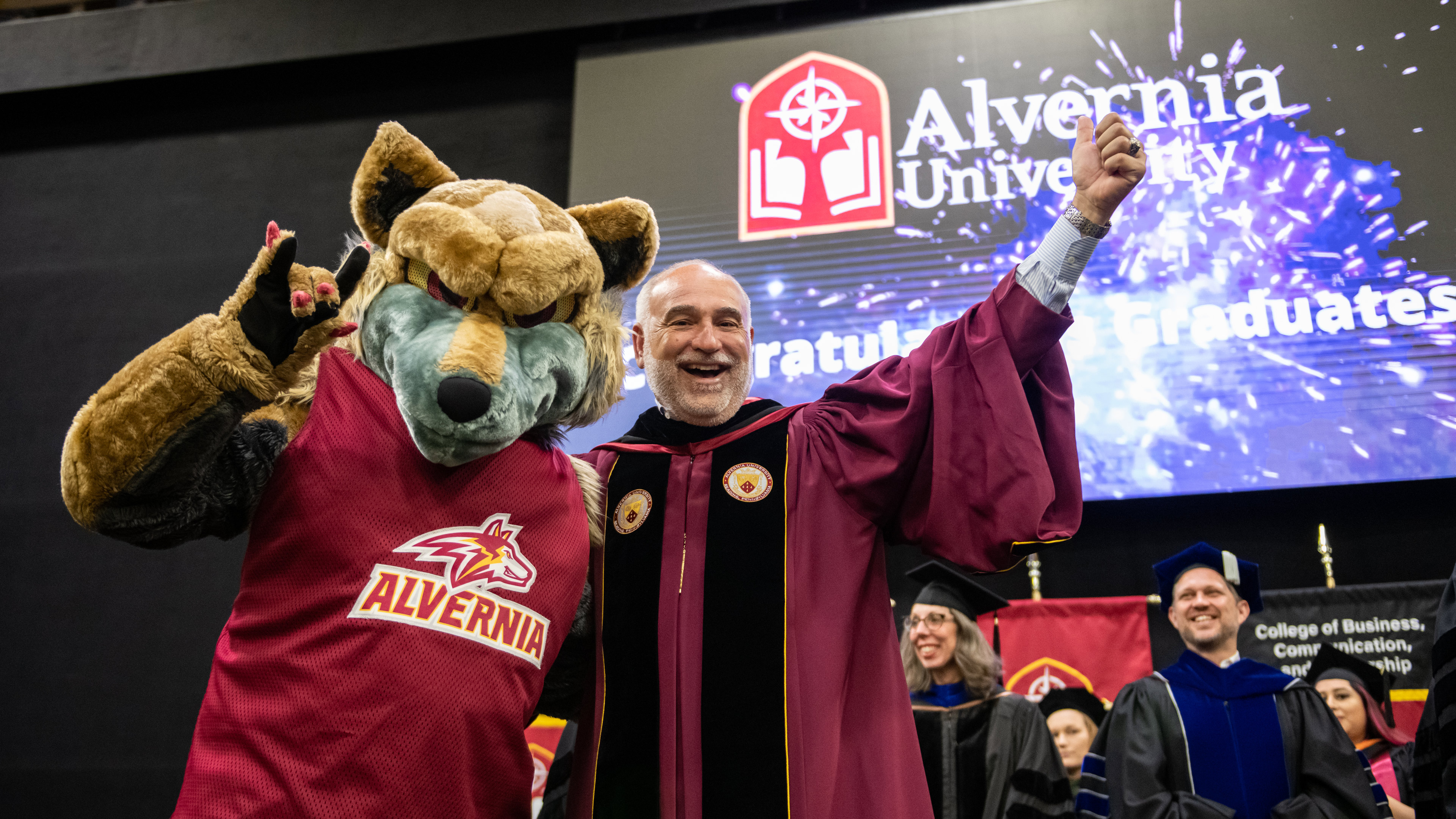 Alvernia President John R. Loyack and the Alvernia Golden Wolf at the 2022 Commencement Ceremony