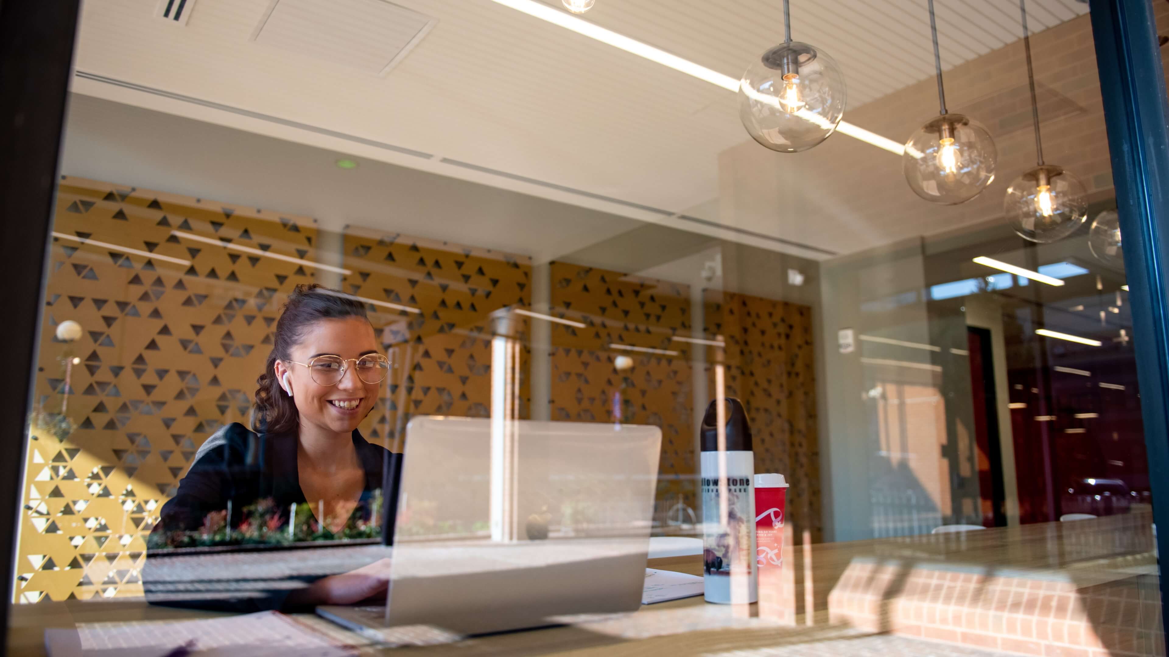 Student studying in lobby of Alvernia University's  John R. Post Center at Reading CollegeTowne in downtown Reading, Pennsylvania.