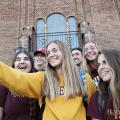 Students posing for a selfie in front of Francis Hall