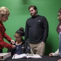 Dr. Jodi Radosh places a student's microphone.