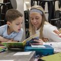 Student volunteer reading at Millmont Elementary