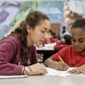 Volunteer helps child with homework
