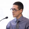 Male undergraduate student at podium