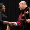 Alvernia University President John R. Loyack shakes hands with a student at the 2022 Honors Convocation