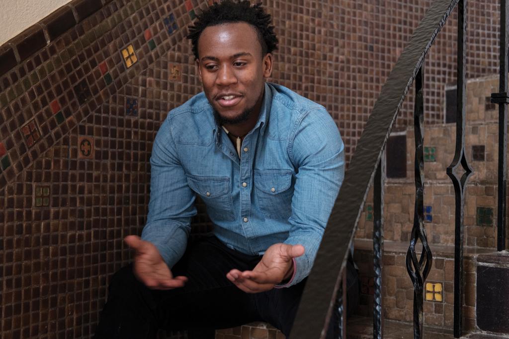 Ephraim Njuguna sitting on stairs