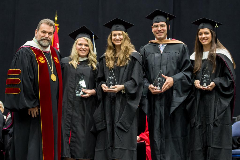 Dr. Flynn presents the 2019 Cohort of Four Under Forty Alumni Awards