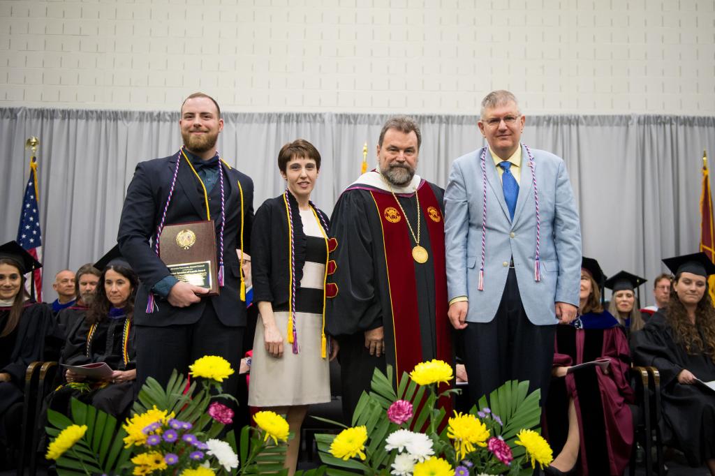 Dr. Flynn poses for a photo with honorees 