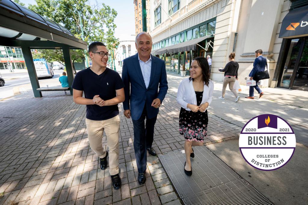 President Loyack walking with student through reading.