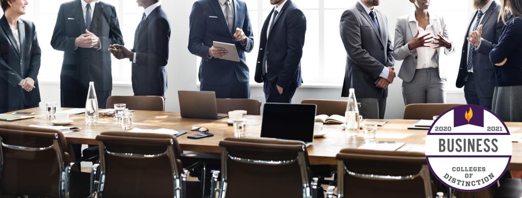 Business people standing at conference table.