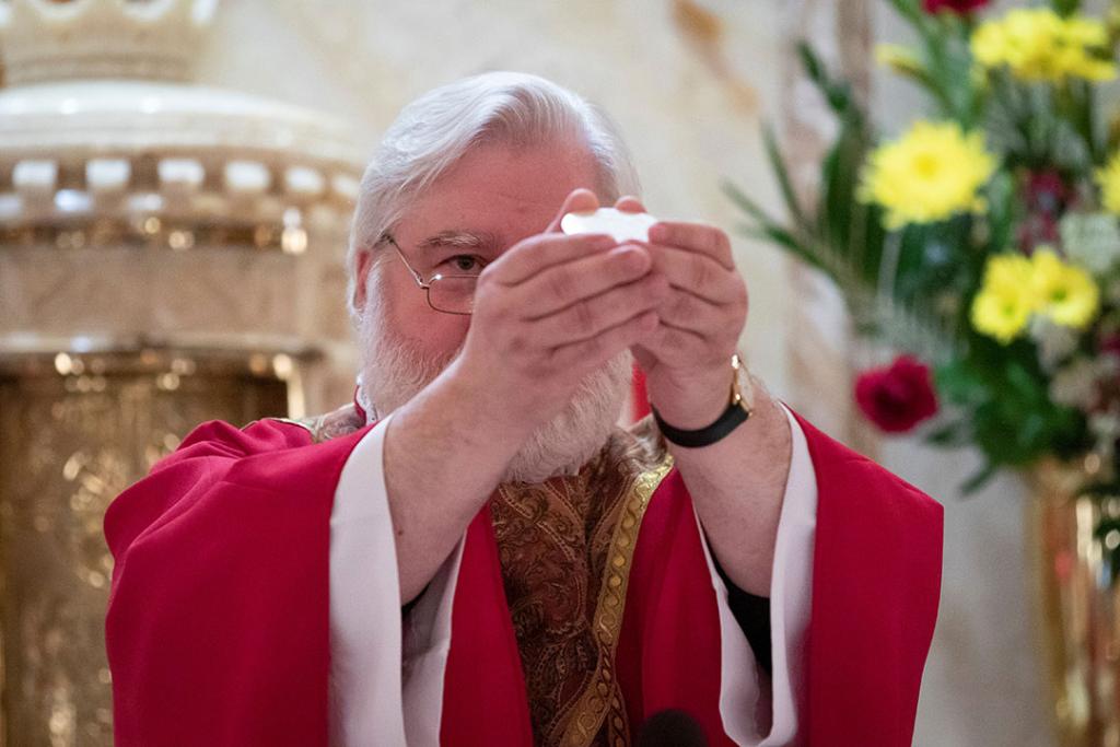 A priest performs Mass.