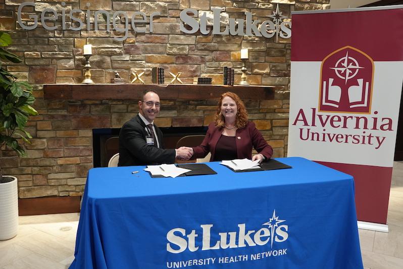 President of Geisinger St. Lukes, Gabe Kamarousky and Alvernia University President-Elect, Dr. Glynis A. Fitzgerald shake on agreement