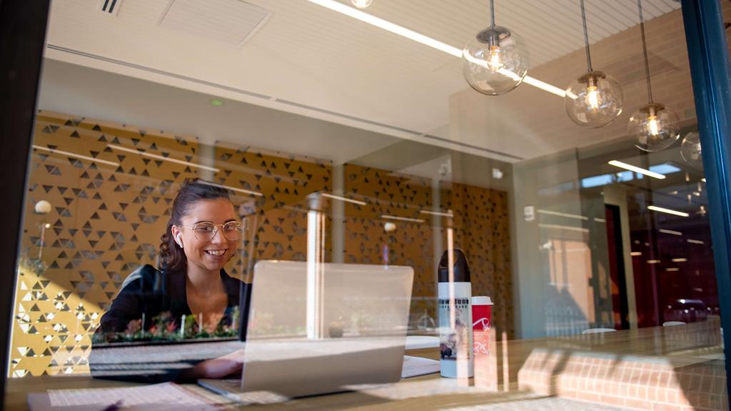 Student studying in lobby of Alvernia University's  John R. Post Center at Reading CollegeTowne in downtown Reading, Pennsylvania.