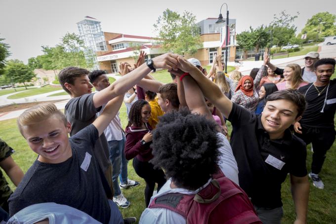 Students join hands in the quad