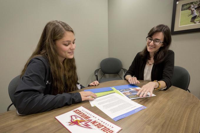 Admissions counselor talks with student