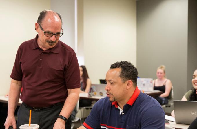 Prof. Reyher instructing an adult student on addictions and mental health treatment.