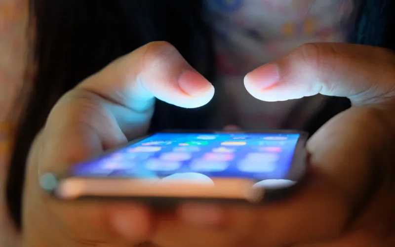 Person typing on phone