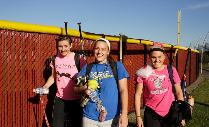 Softball players leave field