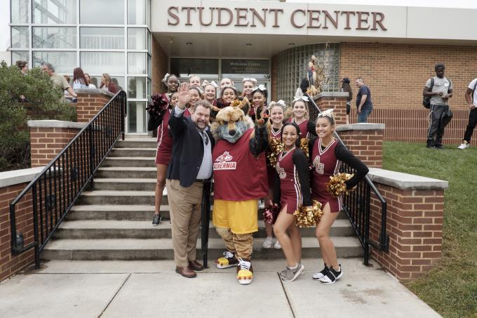 Dr. Flynn and cheerleaders at homecoming
