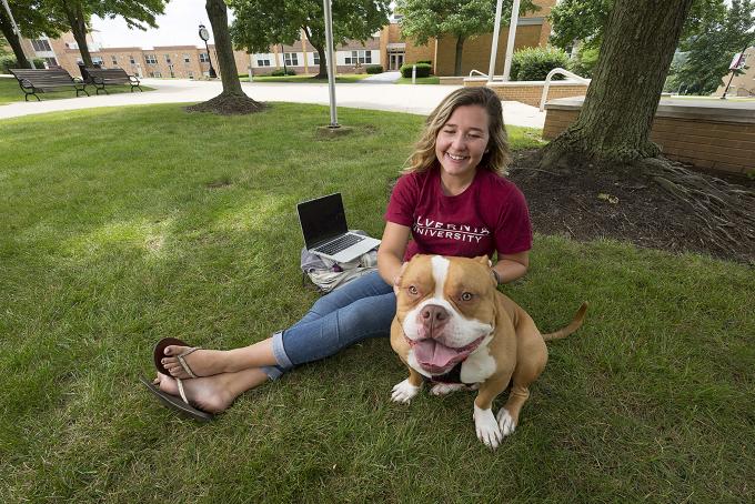 Student with dog on campus