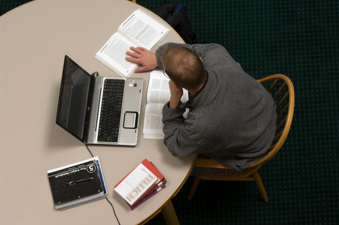 male online student with laptop