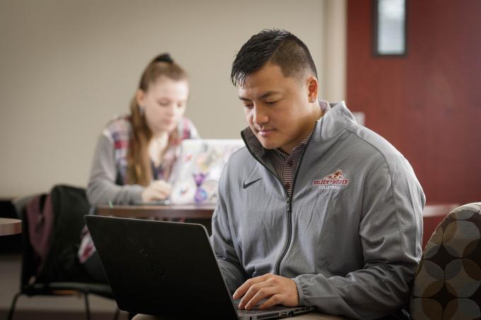 Male graduate student at laptop