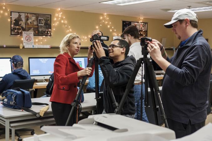 Professor teaches student to use video equipment