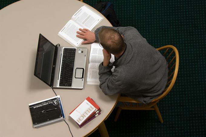 male online student with laptop