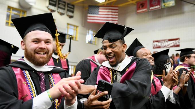 Alvernia students Jacob Paul-Taylor and Tyzhir Morris celebrate at the 2022 Alvernia University Commencement Ceremony