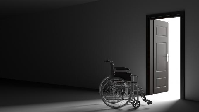 empty wheelchair in dark hallway