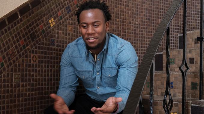 Ephraim Njuguna sitting on stairs