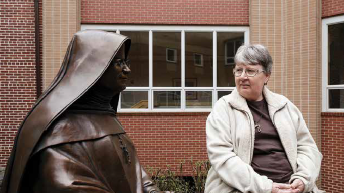 Sister Bridget looking at statue