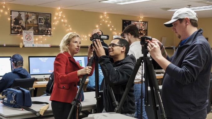 Professor teaches student to use video equipment
