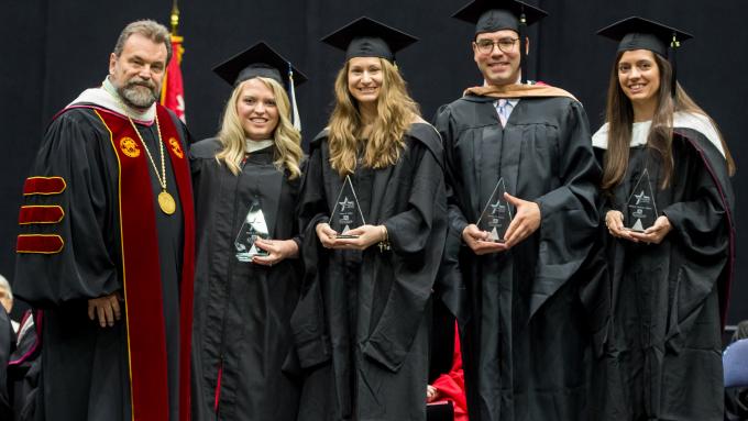 Dr. Flynn presents the 2019 Cohort of Four Under Forty Alumni Awards
