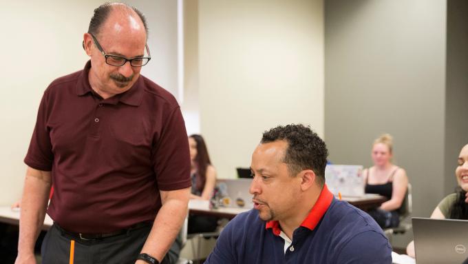 Prof. Reyher instructing an adult student on addictions and mental health treatment.