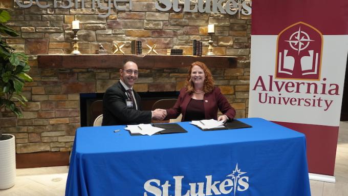 President of Geisinger St. Lukes, Gabe Kamarousky and Alvernia University President-Elect, Dr. Glynis A. Fitzgerald shake on agreement