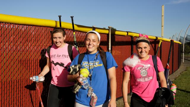 Softball players leave field