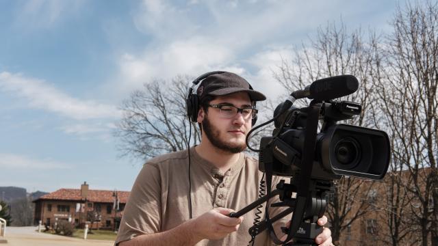 A student shoots video on campus.