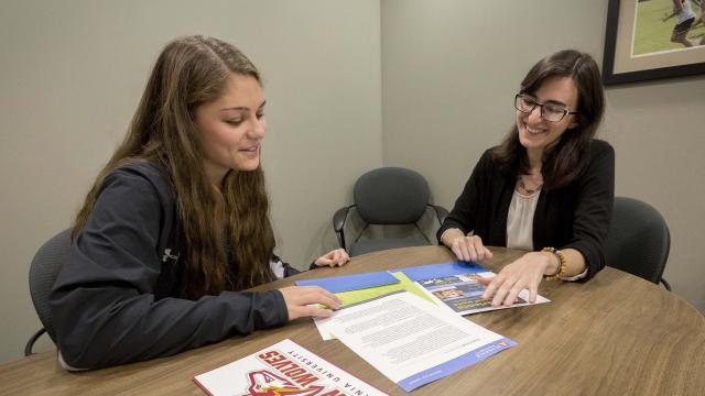 Admissions counselor talks with student