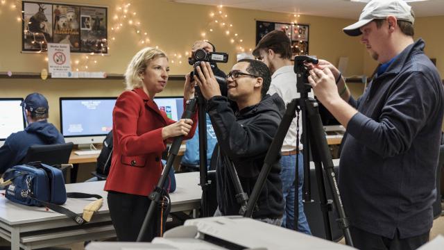 Professor teaches student to use video equipment