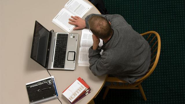 male online student with laptop