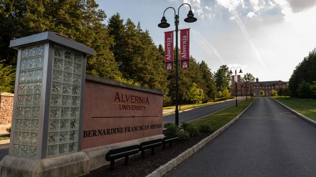 Main entrance to Alvernia University with banners 