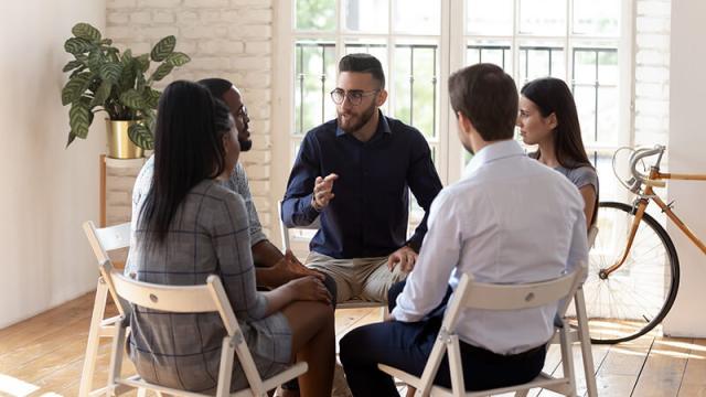 A counselor meets with a group of students.