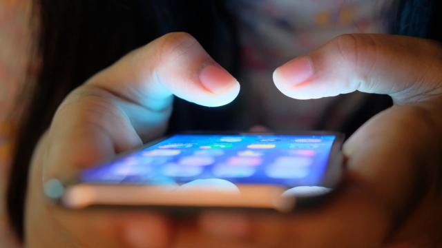 Person typing on phone