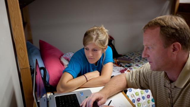 A father and daughter in an Alvernia dorm room.